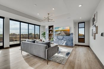 a living room with a couch and a wall of windows